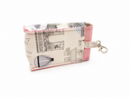 A small fabric zip pouch with a pink and cream print featuring architectural sketches and a hot air balloon, finished with a pink trim and a silver metal clasp.